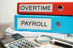 Overtime Payroll. Binder data finance report business with graph analysis in office. photo