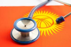 Stethoscope on Kyrgyzstan flag background, Business and finance concept. photo