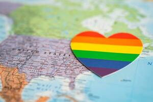 Bangkok, Thailand, June 1, 2022 Rainbow color heart on USA America globe world map background, LGBT pride month. photo