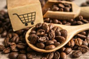 Box with shopping cart logo symbol on coffee beans, Import Export Shopping online or eCommerce delivery service store product shipping, trade, supplier concept. photo