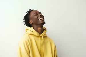 black guy smiling wearing yellow long sleeve shirt on white background photo