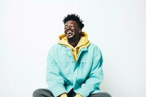 black guy smiling wearing blue long sleeve shirt on blue background photo