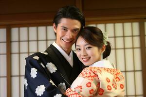 married japanese couple smiling posing together in traditional clothing kimono and hakama bokeh style background photo