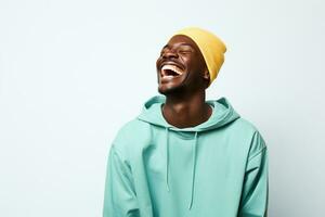 black guy smiling wearing blue long sleeve shirt on blue background photo