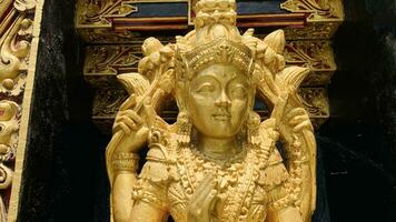 Balinese Hindu God golden Shiva Durga statue on a sacred Hindu temple in Indonesia photo