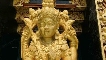 Balinese Hindu God golden Shiva Durga statue on a sacred Hindu temple in Indonesia photo