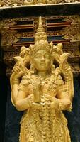 Balinese Hindu God golden Shiva Durga statue on a sacred Hindu temple in Indonesia photo