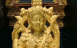 Balinese Hindu God golden Shiva Durga statue on a sacred Hindu temple in Indonesia photo