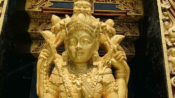 Balinese Hindu God golden Shiva Durga statue on a sacred Hindu temple in Indonesia photo