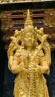 Balinese Hindu God golden Shiva Durga statue on a sacred Hindu temple in Indonesia photo