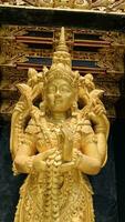 Balinese Hindu God golden Shiva Durga statue on a sacred Hindu temple in Indonesia photo