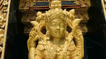 Balinese Hindu God golden Shiva Durga statue on a sacred Hindu temple in Indonesia photo