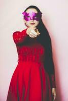 Portrait of beautiful woman in evening dress and golden masquerade mask. Valentines day, Carnival, Festive Ball, Birthday celebration concept. Facial expressions of young female photo