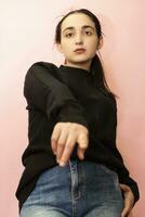 Portrait of a young and stylish middle-eastern woman in casual clothing. Attractive female posing in studio photo