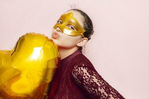 Woman wearing masquerade mask and holding heart shaped air ballon. Valentines Day, Birthday, Anniversary, Festive, Ball celebration concepts photo