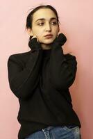 Portrait of a young and stylish middle-eastern woman in casual clothing. Attractive female posing in studio photo