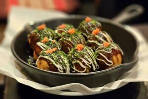 Takoyaki in Hot Plate that is a Famous Japanese Recipe. photo