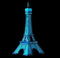 a blue glow in the dark eiffel tower photo