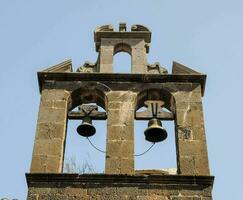 a bell tower with two bells on top photo