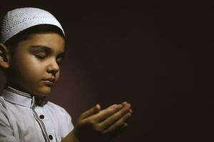 Praying muslim boy photo