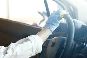 Car disinfecting service. Cleansing car interior and spraying with disinfection liquid photo