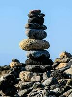 a stack of rocks on a rocky beach photo