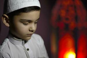 Praying muslim boy photo