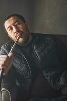 A guy smokes hookah in shisha bar photo