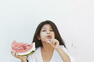 Pre-teen girl eating watermelon. Happy childhood. Summer girl. photo