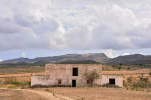 an old building in the middle of a desert photo