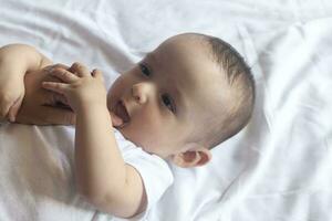 Baby teething. Baby tooth care concept. Mother checking her baby boy mouth. First signs of baby teeth come in. Infant teething pain. photo