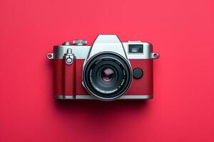 Retro camera isolated on red background. Flat lay, top view photo