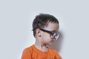 A cute little boy wearing big eyeglasses photo