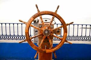 a wooden steering wheel on a boat photo