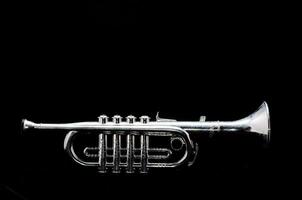 a silver trumpet on a black background photo