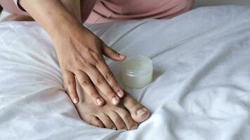 woman using petroleum jelly on feet video