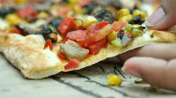 closeup of hand picking slice of pizza video