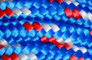 a close up of a blue, white and red braided rope photo