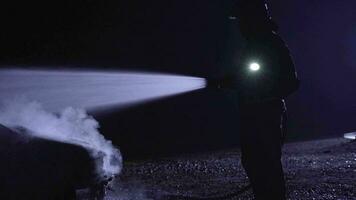 Unrecognizable fireman combating a fire with water hose. video