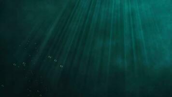 Underwater scene with sun light beams shining from above and air bubbles rising up to the surface. video