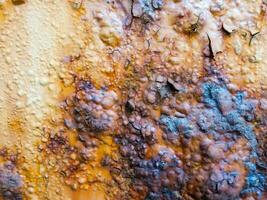 rusty metal surface with some paint on it photo