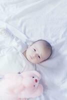 Cute newborn baby boy with easter pink easter bunny photo