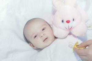 Cute newborn baby boy with easter pink easter bunny photo