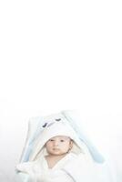 Adorable cute newborn baby boy on white background. The lovely child wore a rabbit costume with long ears. Holiday, Easter. photo