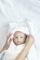 Adorable cute newborn baby boy on white background. The lovely child wore a rabbit costume with long ears. Holiday, Easter. photo