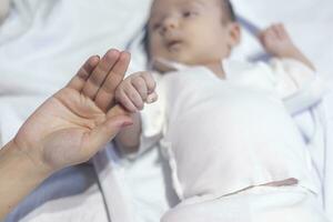 mother and newborn baby hands photo