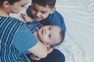 Happy childhood concept. Happy brothers portrait. 6 years and 6 months old boys having fun. Two little kids smiling having good time. Cute little brothers lying and playing together photo