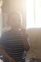 A little boy eating strawberries. Summer food. A young kid eats a yummy strawberry in hot summer day photo