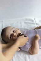 A doctor gives newborn baby rotavirus vaccine. Child immunization with little drop in clinic.Baby boy gets medicine from a little bottle photo