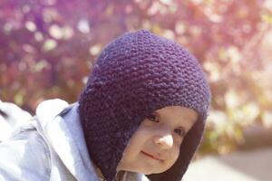 Portrait of 2-3 years old child in autumn garden photo